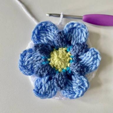 Round 6. Pale blue crochet granny square flower in progress