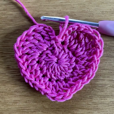 pink crochet heart with crochet hook