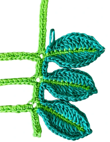 Close up of 3 crochet leaves green showing the stitches used for the crochet leaves stem free pattern.